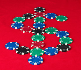 poker chips in the form of dollars on a red table
