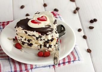 sweet cake with chocolate on plate on wooden table
