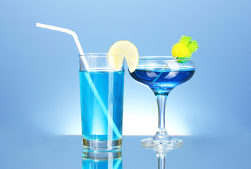 a variety of alcoholic drinks on blue background