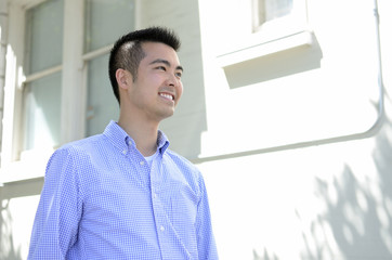 Head shot of a young Asian man smiling