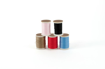 Sewing thread in different colors,isolated on white background