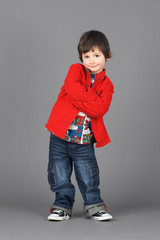 Cute little boy in red with smirk
