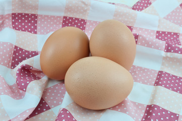 Macro shoot of brown eggs on a white background