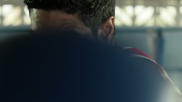 Young hispanic man exercising in boxing gym