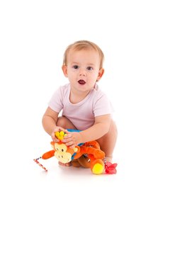 Cute baby girl playing with soft toy