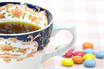 Cup of coffee and colorful chocolate
