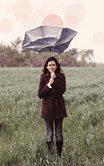 Young woman with umbrella. Photo in old color image style.