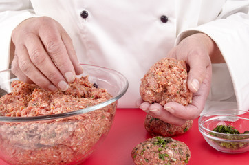 female chef making meat balls