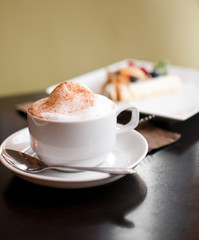 A cappuccino cup with milk foam and cinnamon