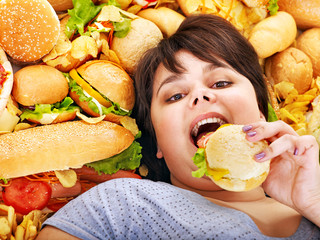 Woman eating hot dog.