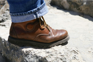 Man's boot on stone