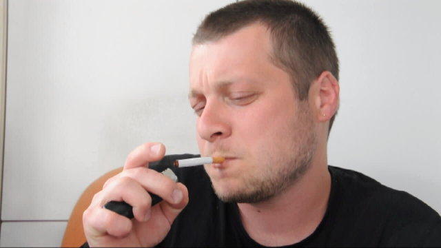 A young man smokes a cigarette