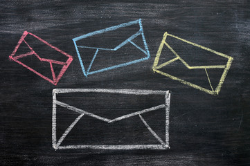 Chalk drawing of email symbols on a blackboard