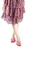 Woman Wearing Red Flip Flops and Floral Skirt
