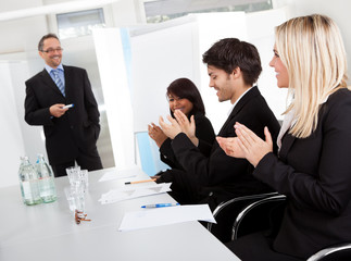 Business people at presentation applauding