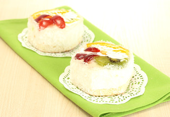 sweet cake with fruits on wooden table