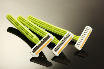 woman safety shavers and flowers on grey backgroud.