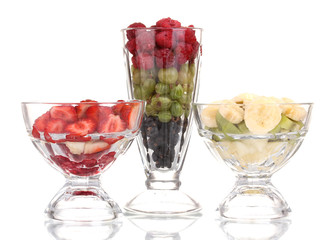 Mixed fruits and berries in glasses isolated on white