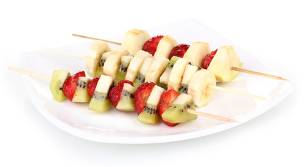 Mixed fruits and berries on skewers isolated on white
