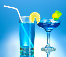 a variety of alcoholic drinks on blue background
