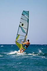 Rear view of young windsurfer