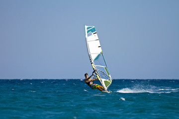 Young male windsurfer in action