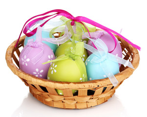 Colorful easter eggs in basket isolated on white
