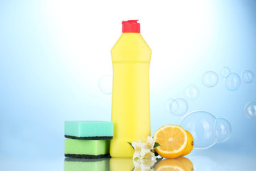 Dishwashing liquid with sponges and lemon with flowers