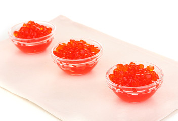 Red caviar in glass bowls isolated on white