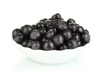 ripe blueberries in white bowl isolated on white