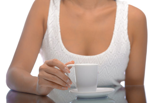 Girl with a cup of coffee over mirrow table