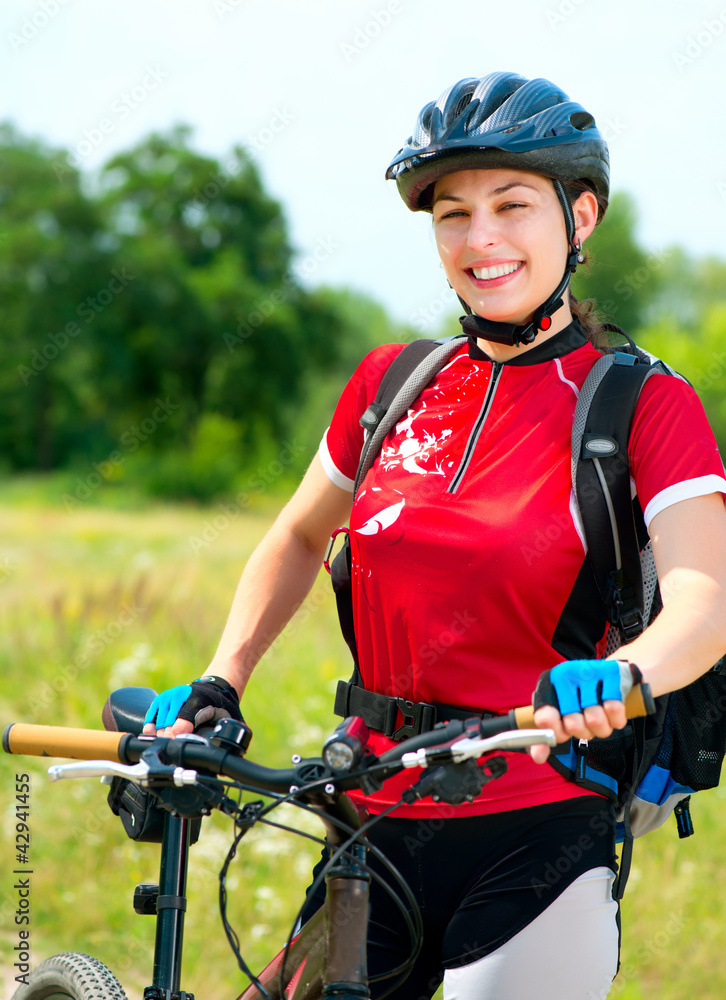 Wall mural Happy Young Woman riding bicycle outside. Healthy Lifestyle