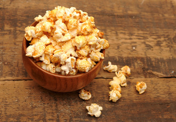 popcorn in brown bowl on wooden table