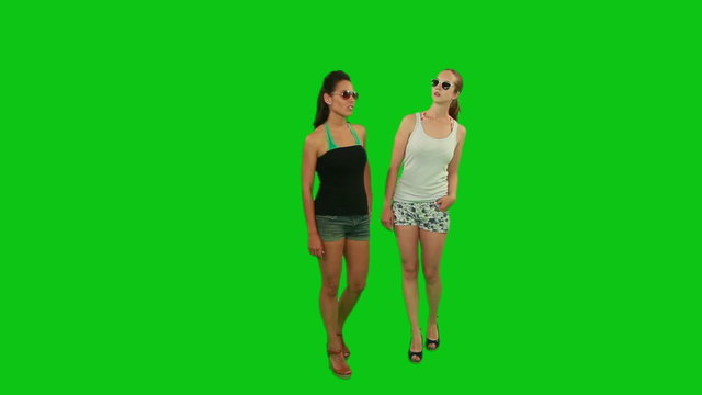 Two young women thinking where to go. Green Screen