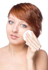 beautiful young female cleaning face skin