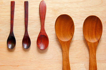 Collection of wooden kitchen spoons on wood background