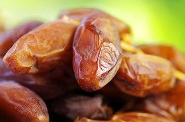 Fresh dates isolated on green background