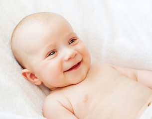laughing baby on white towel