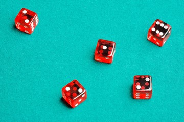 group of red dices on the green cloth