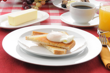 Poached egg breakfast on toast with coffee