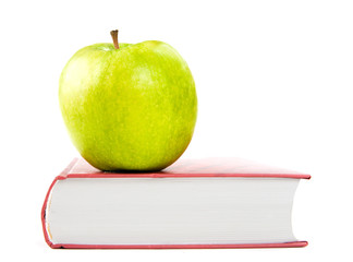 A green apple on a book