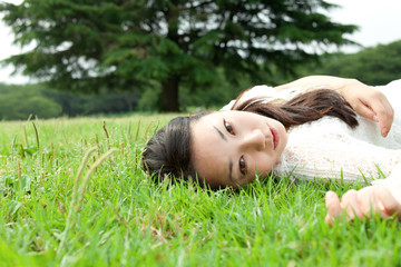 Beautiful young woman on the green