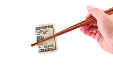 Hand with chopsticks and  US Dollars banknotes isolated on white