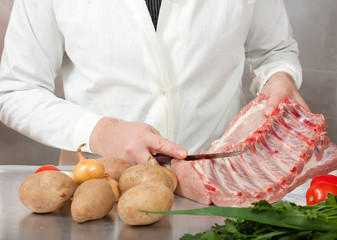 hands with raw meat and vegetables