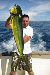 Fotobehang Vissen Lucky  fisherman holding a beautiful dolphin fish  © sablin