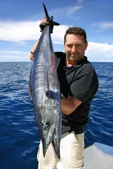 Foto auf Acrylglas Lucky  fisherman holding a beautiful wahoo fish © sablin