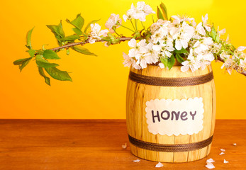 Sweet honey in barrel with blossoming branch