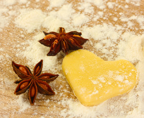 molded the dough with anise on wooden table close-up