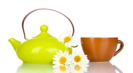 Teapot and cup with chamomile tea isolated on white