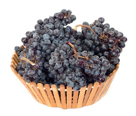 black grapes in a basket on a white background
